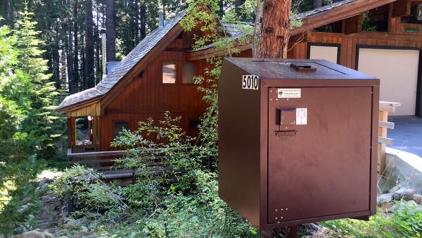 bear box bear resistant trash container in front of tahe west shore home - tahoe bear busters